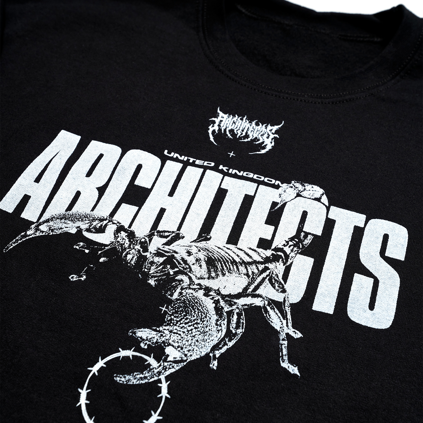 Black unisex crewneck featuring a white Architects Scorpio print across the front and a barbed wire print across the sleeves.