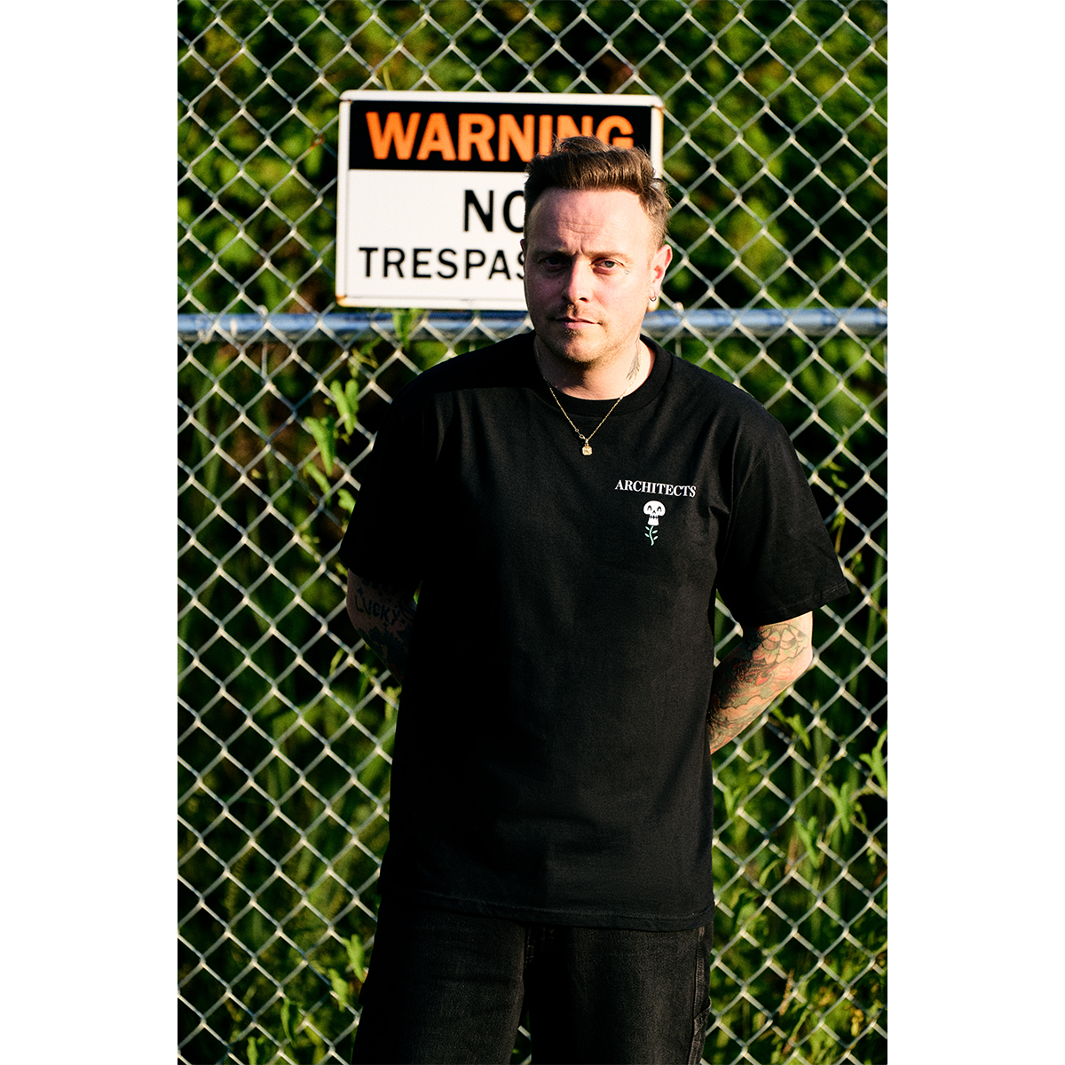 Black short-sleeve unisex T-shirt featuring an Architects flower skull print on the front right chest.