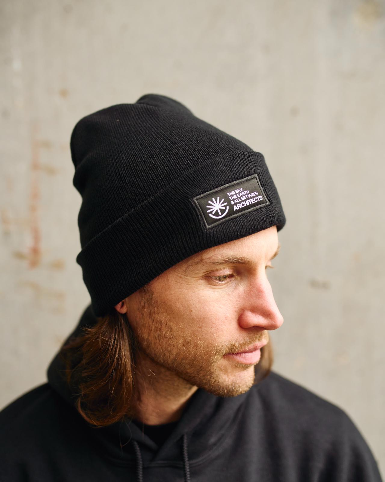 Black unisex Beanie with Architects The Sky, the Earth and All Between text patch across the front