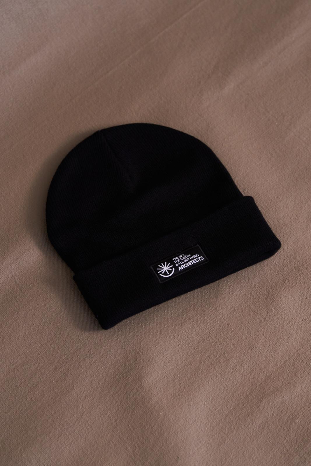 Black unisex Beanie with Architects The Sky, the Earth and All Between text patch across the front
