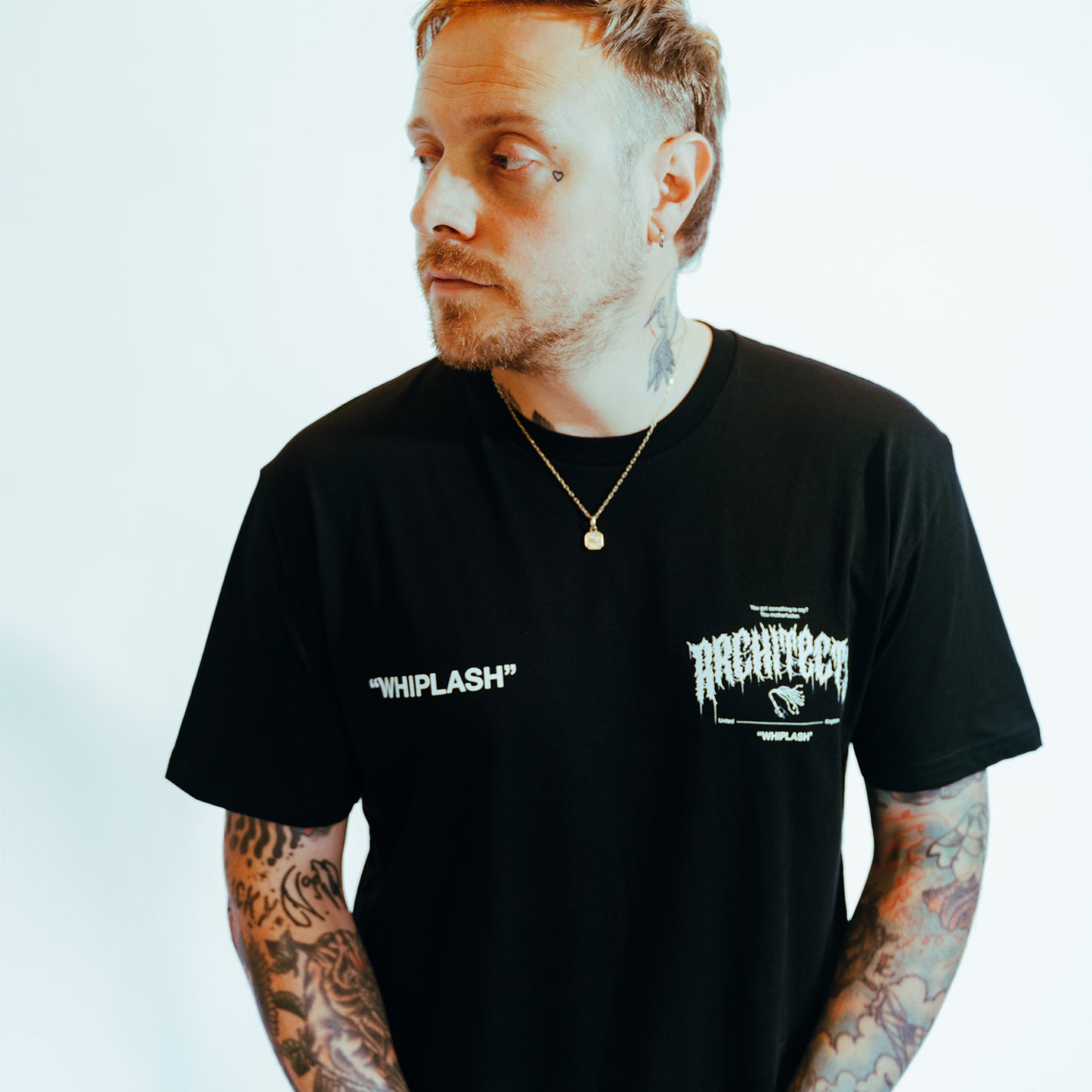 Black unisex short-sleeve T-Shirt with white Architects Whiplash text print across the front chest