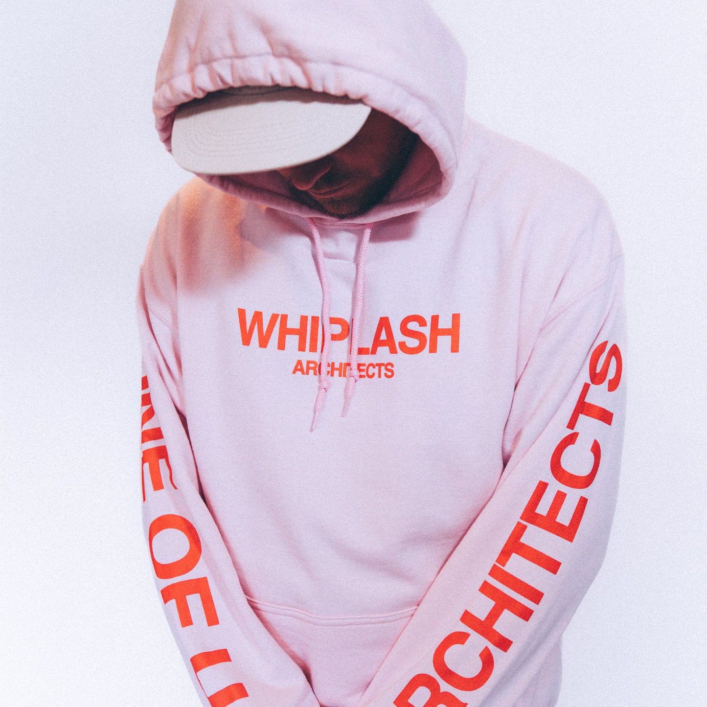 Pink regular-fit hoodie with red Architects 'Whiplash' print across the front and 'One of Us' print across the sleeves.