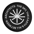 Round black patch with white text and symbol on a white background