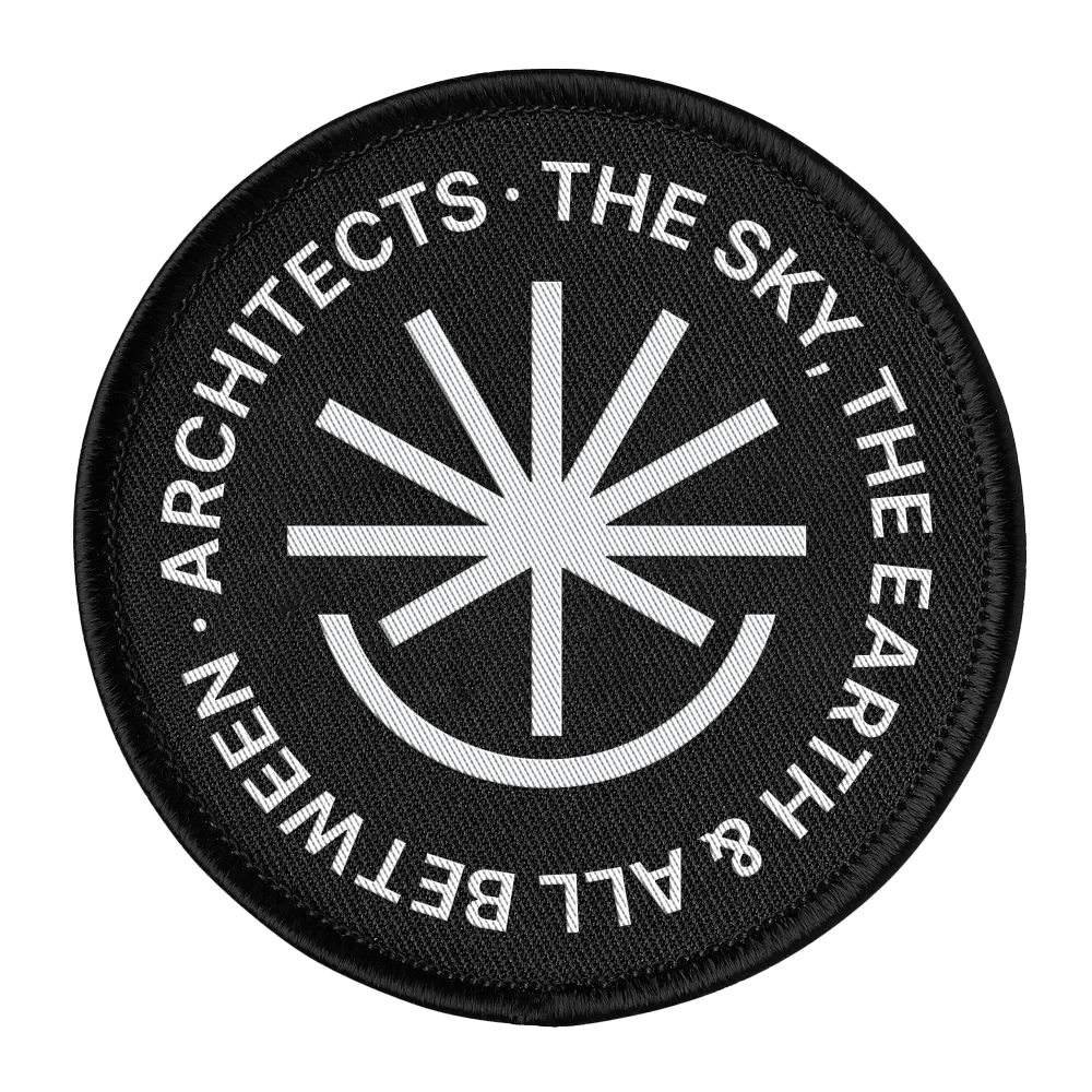 Round black patch with white text and symbol on a white background