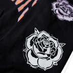 Black regular-fit unisex hoodie featuring an orange Architects print across the front, with blue, pink, and white rose prints along the sleeves.