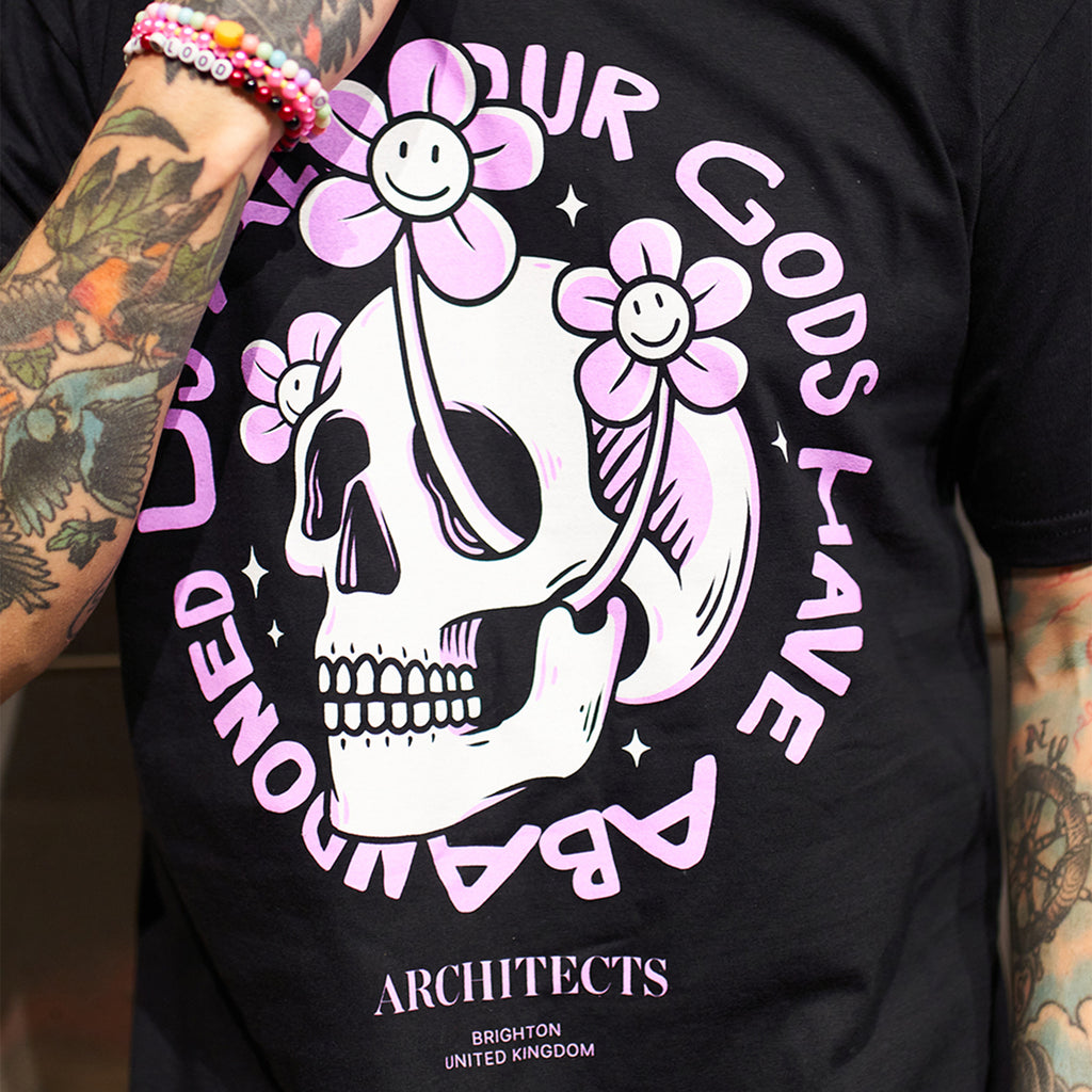Black Unisex short-sleeve t-shirt with pink Architects "All Our God Have Abandoned Us" skull print across the front