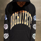 Black regular-fit unisex hoodie featuring an orange Architects print across the front, with blue, pink, and white rose prints along the sleeves.