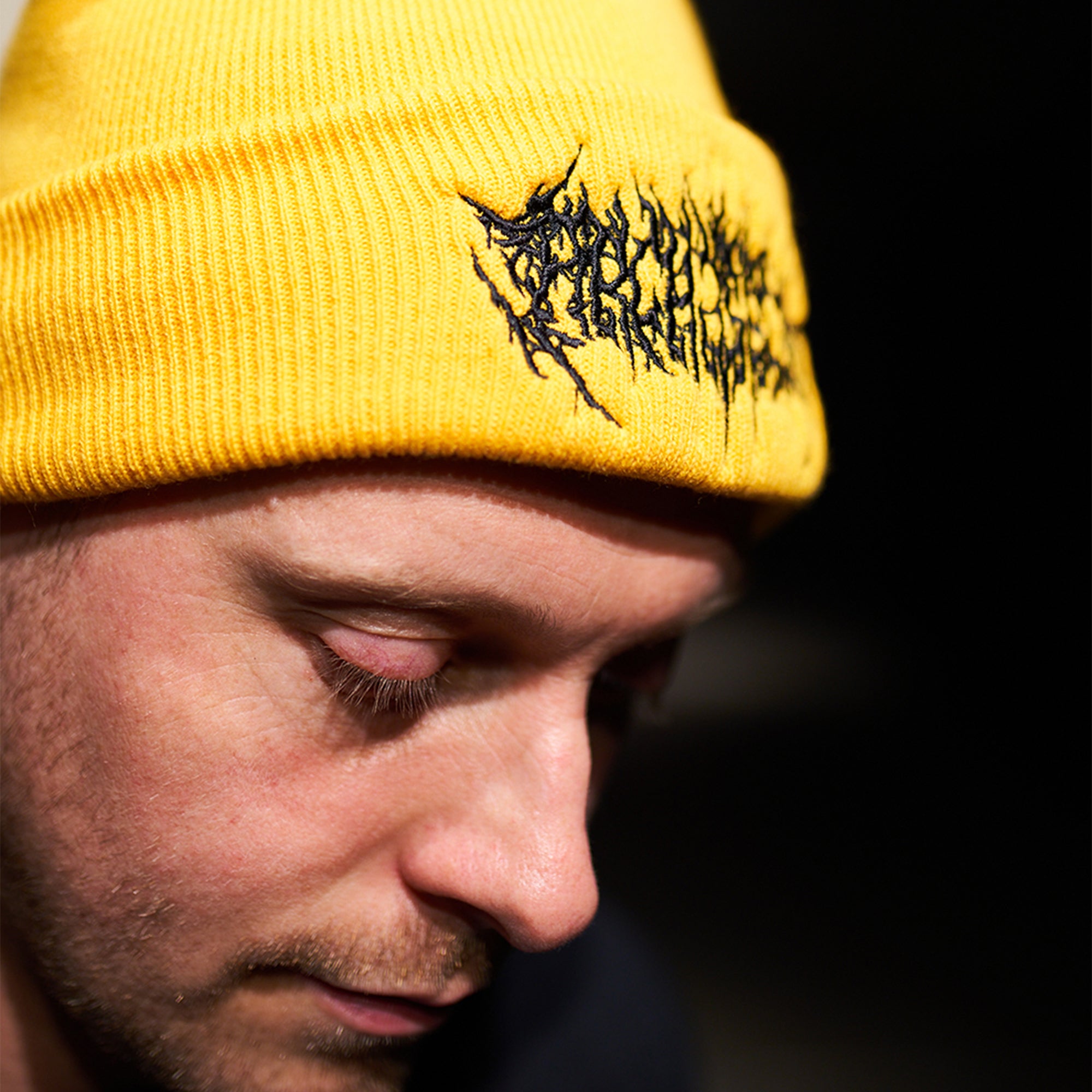 Yellow beanie featuring Barbed Wire Architects embroidery across the front