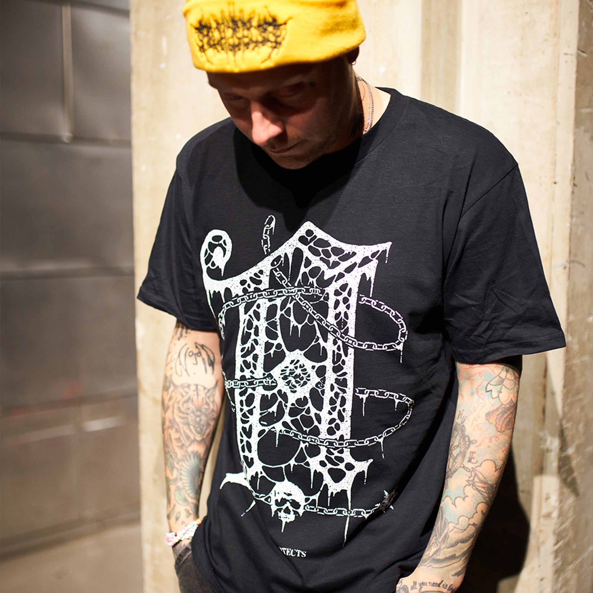 Yellow beanie featuring Barbed Wire Architects embroidery across the front