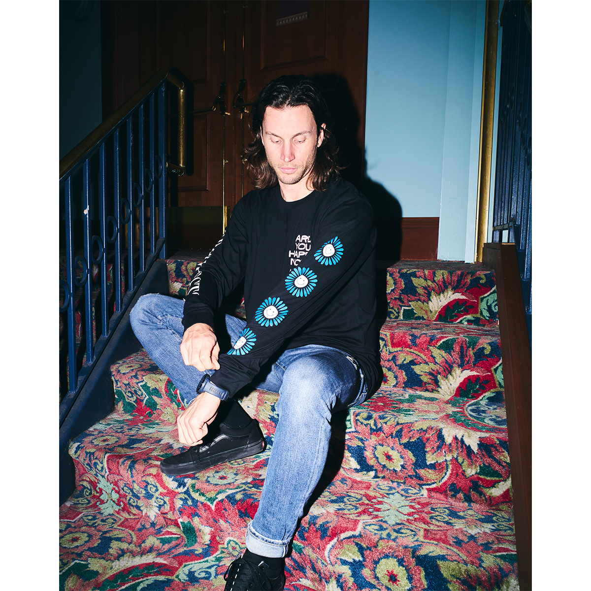 Black unisex long-sleeve T-shirt featuring a pink 'Are You Happy Now' print on the chest, with white and blue Architects prints along the sleeves.