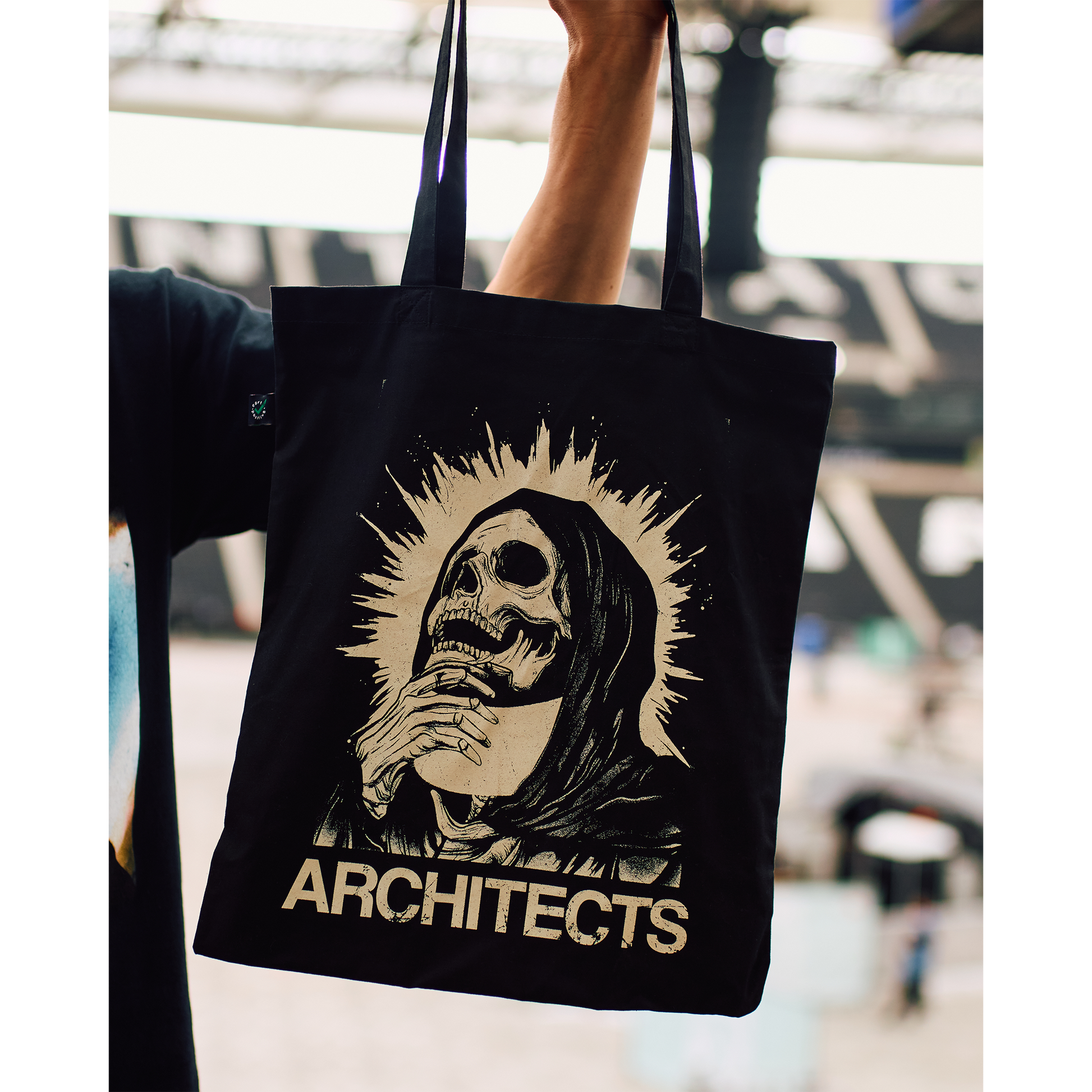 Black tote bag with a graphic skull design and 'ARCHITECTS' text print.