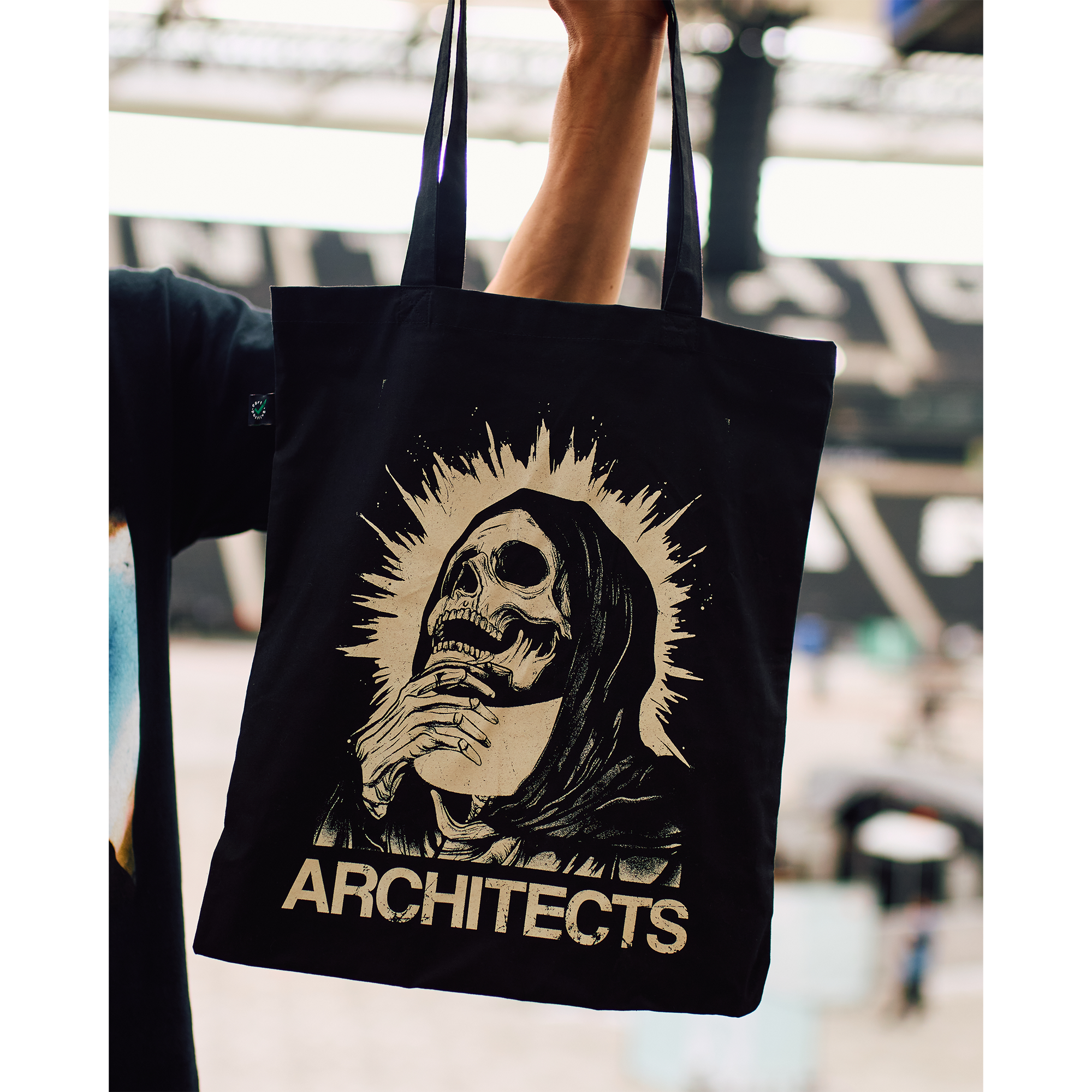 Black tote bag with a graphic skull design and 'ARCHITECTS' text print.