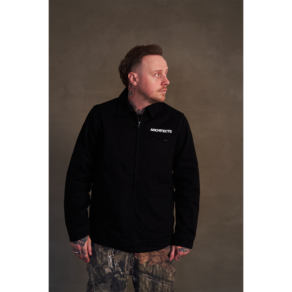 Black canvas jacket featuring white Architects text print on the front right chest and The Sky, the Earth and All Between text print across the back.