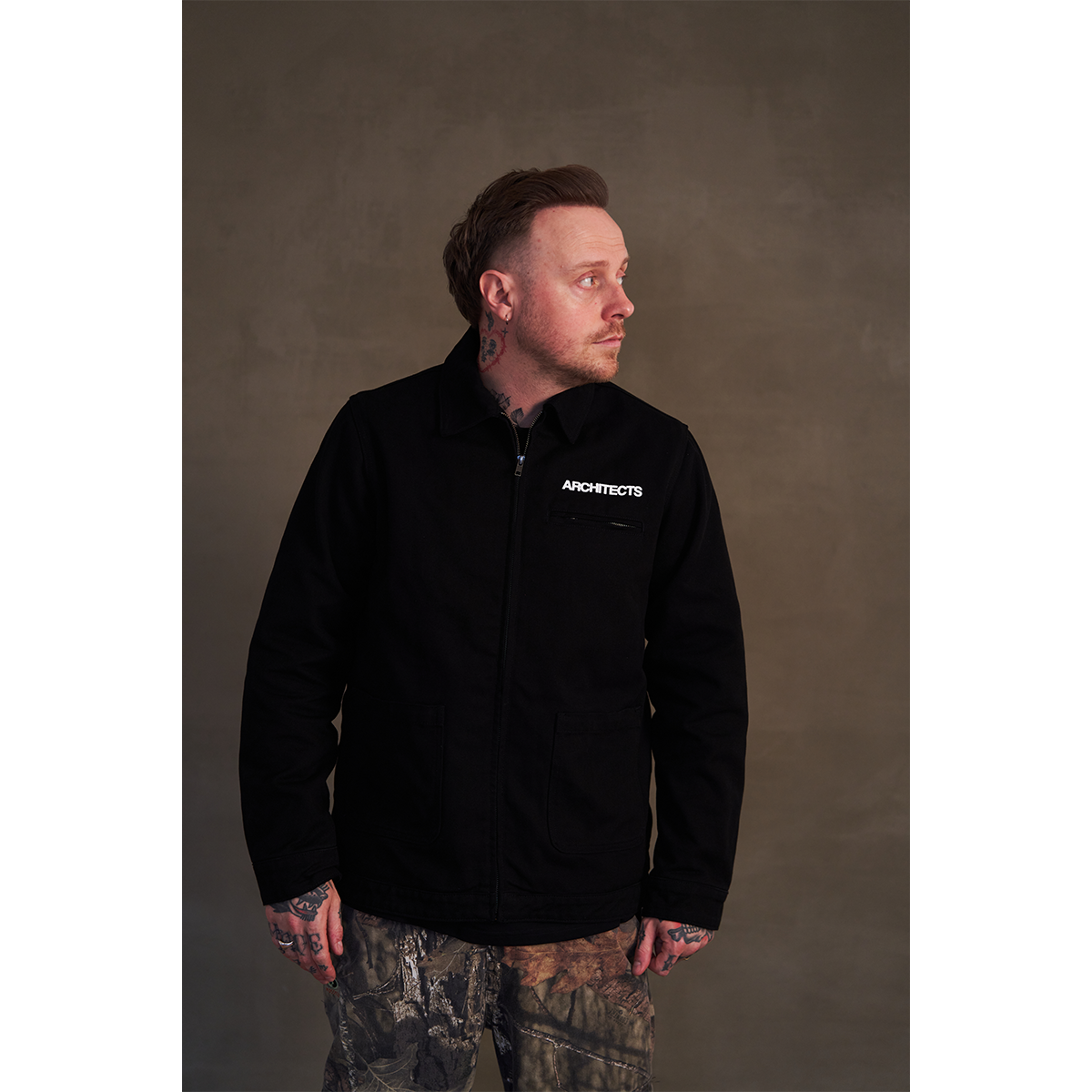 Black canvas jacket featuring white Architects text print on the front right chest and The Sky, the Earth and All Between text print across the back.