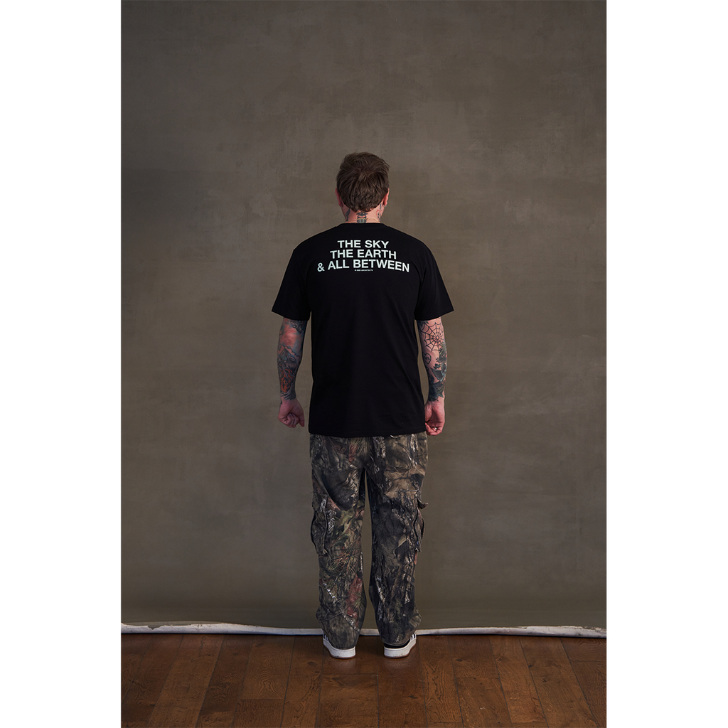 Black short-sleeve unisex regular fit T-shirt featuring the Architects Glow print across the front and The Sky, the Earth & All Between text print across the back.