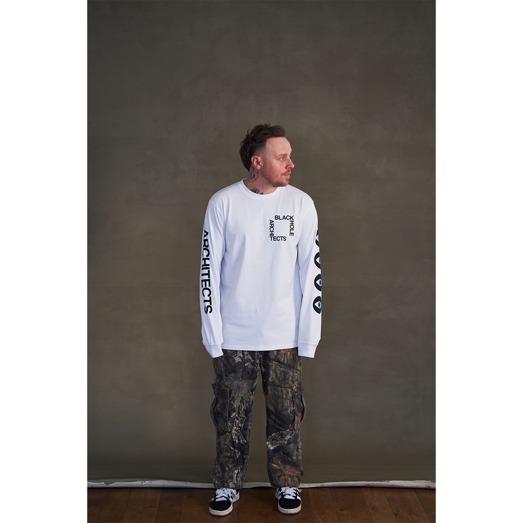 White long-sleeve unisex regular fit T-shirt with Architects Blackhole print on the front right chest, Architects text along the right sleeve, and eye print along the left sleeve.