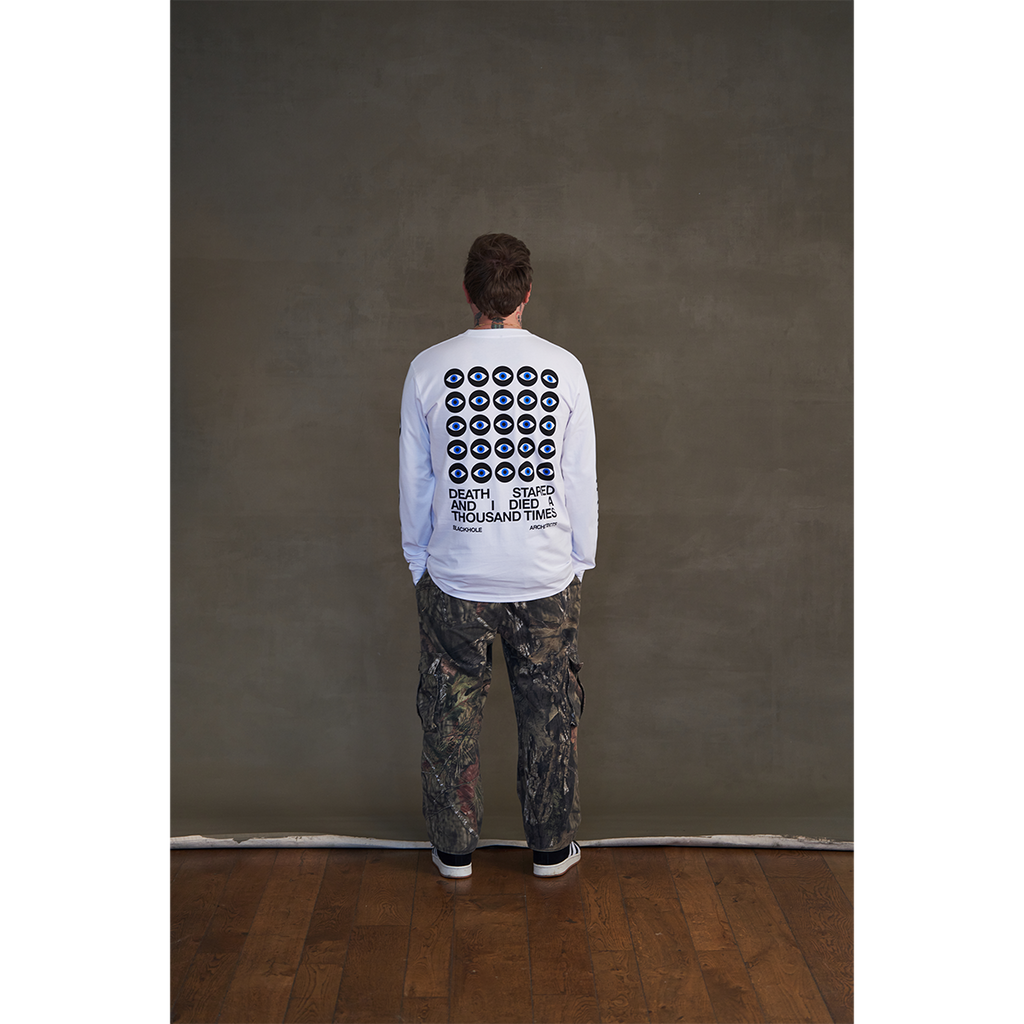 White long-sleeve unisex regular fit T-shirt with Architects Blackhole eye print across the back, Architects text along the right sleeve, and eye print along the left sleeve.