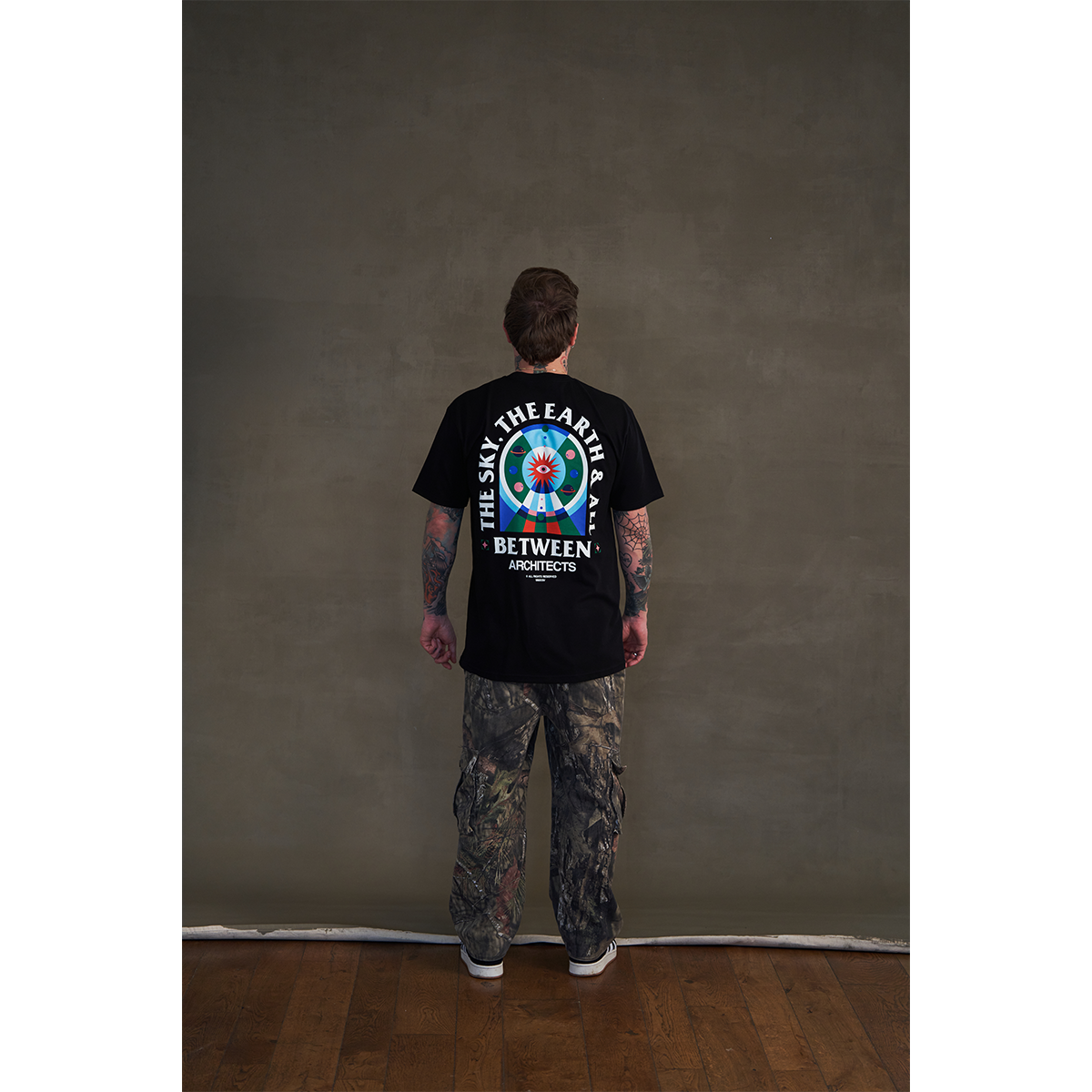 Black short-sleeve unisex regular fit T-shirt featuring Architects The Sky, The Earth & All Between print on the front right chest and across the back.