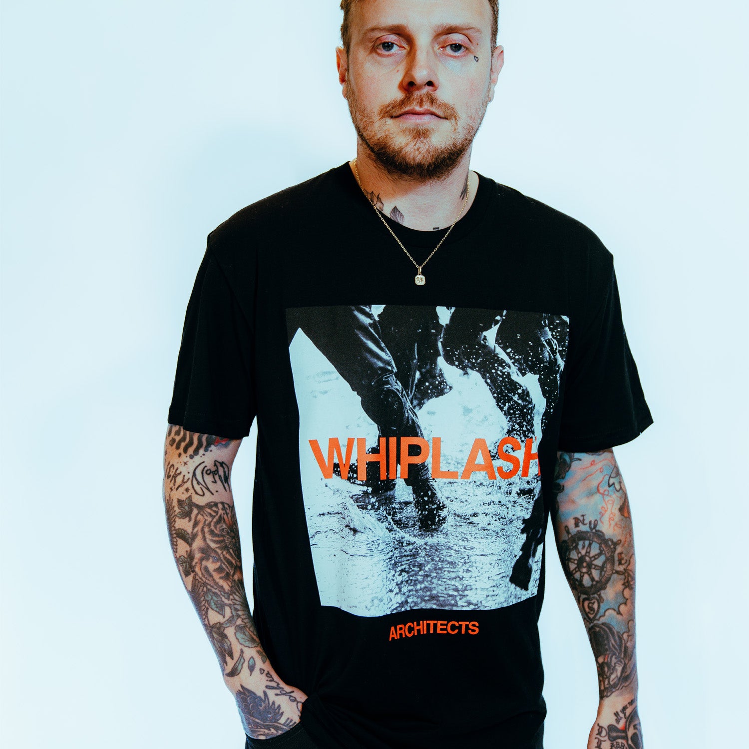 Black short-sleeve unisex T-shirt featuring a grey and red Architects "Whiplash" print across the front.